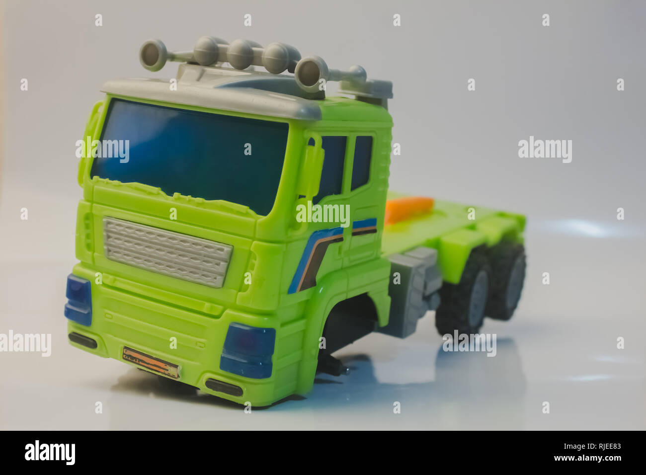 truck broken wheel car toy child lorry green close up with white