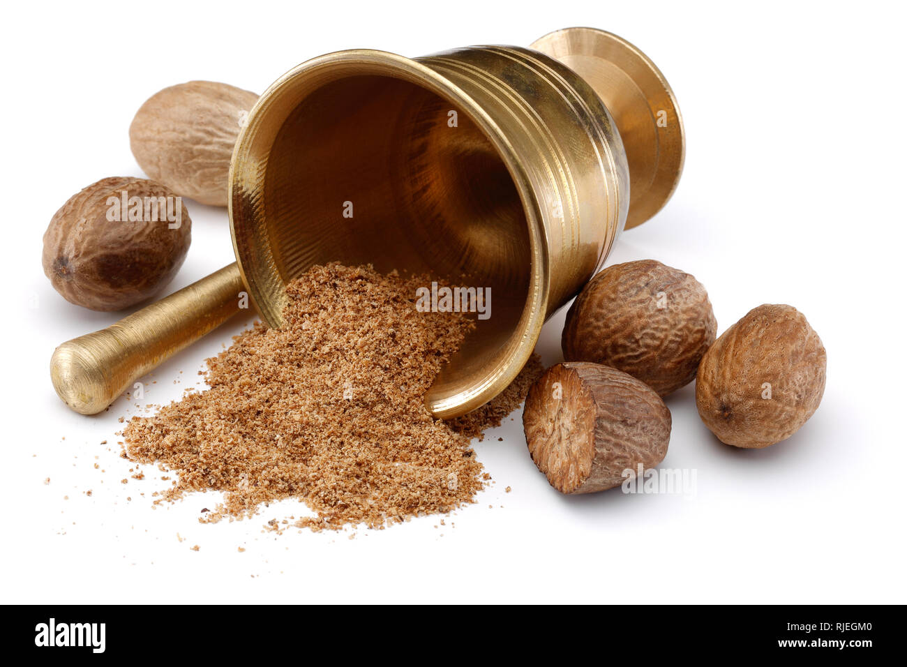 Nutmegs and nutmeg powder in bronze bowl Stock Photo