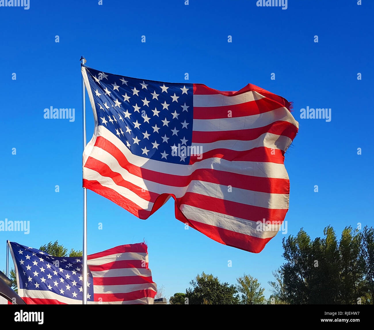 on Thanksgiving Day the flag of the United States of America flies with the wind of freedom in the blue sky and defends all American citizens Stock Photo