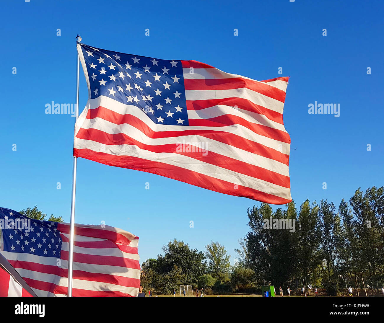on Thanksgiving Day the flag of the United States of America flies with the wind of freedom and protects families Stock Photo