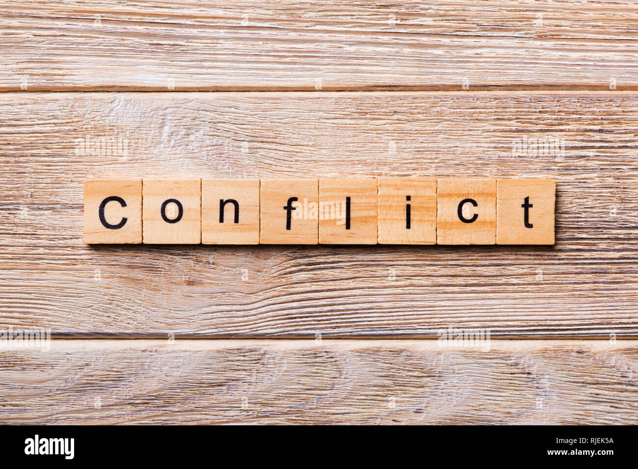CONFLICT word written on wood block. CONFLICT text on wooden table for your  desing, concept Stock Photo - Alamy
