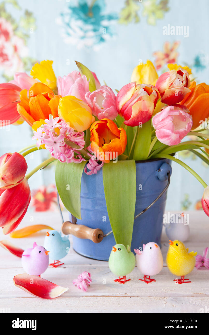 Colorful spring flowers in a little vintage bucket Stock Photo - Alamy