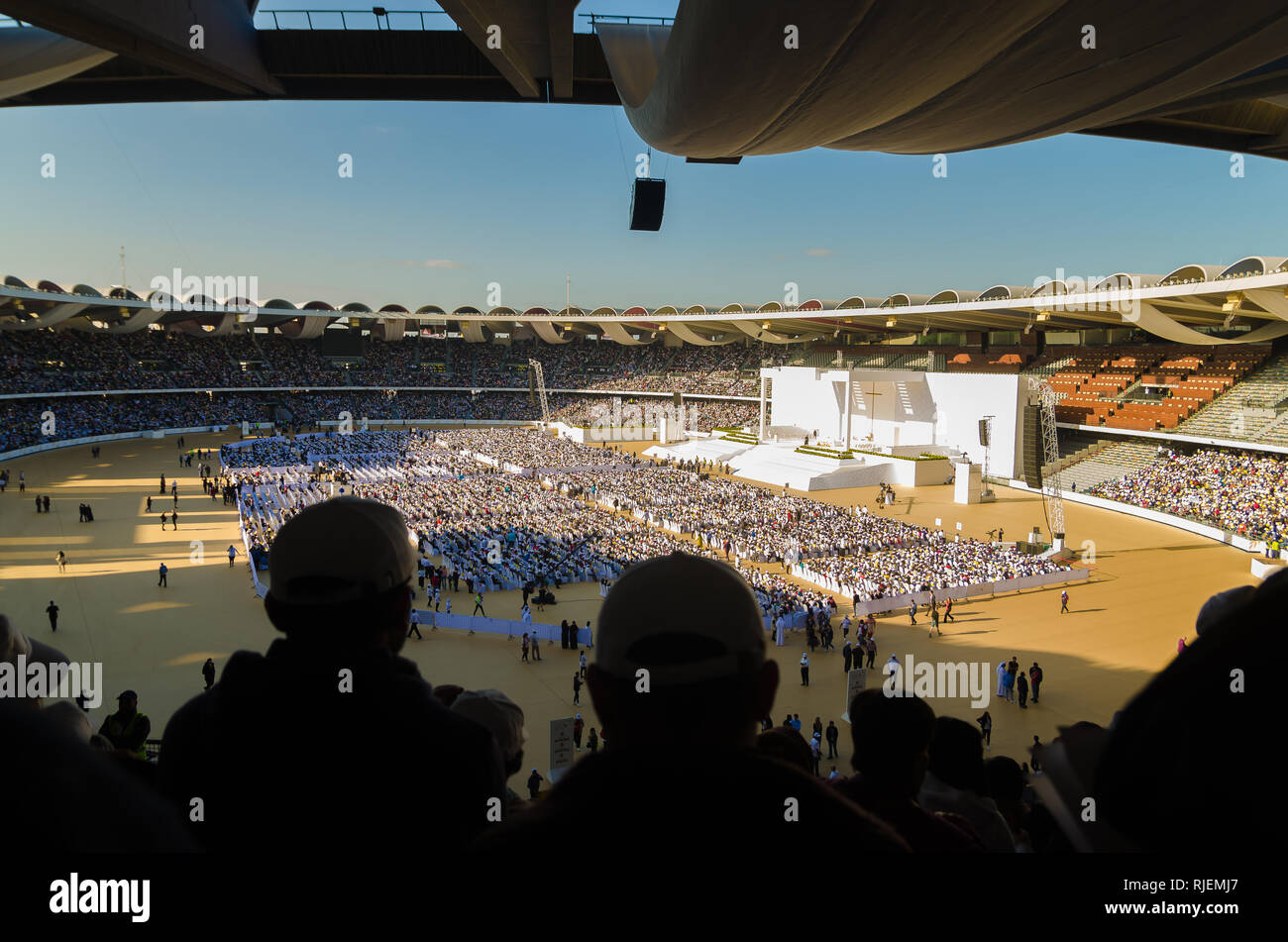 ABU DHABI, UNITED ARAB EMIRATES-FEBRUARY 5, 2019: Attendees of Pope Francis historic papal visit on February 5, 2019 in Zayed Sports City Stadium. Stock Photo
