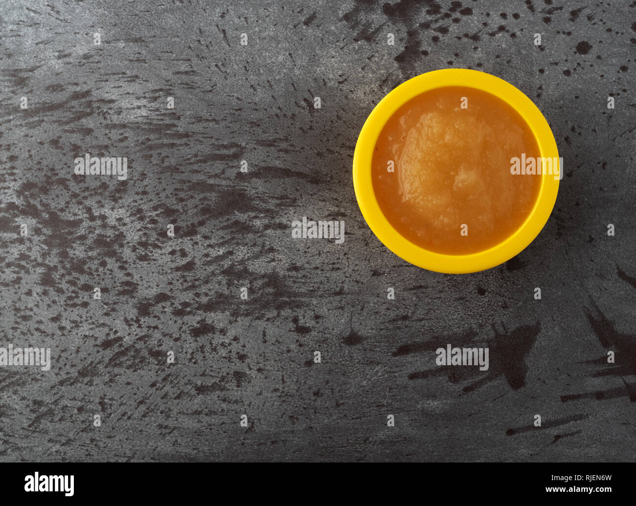 Download Overhead View Of A Small Yellow Bowl Filled With Applesauce Offset On A Gray Background Stock Photo Alamy PSD Mockup Templates