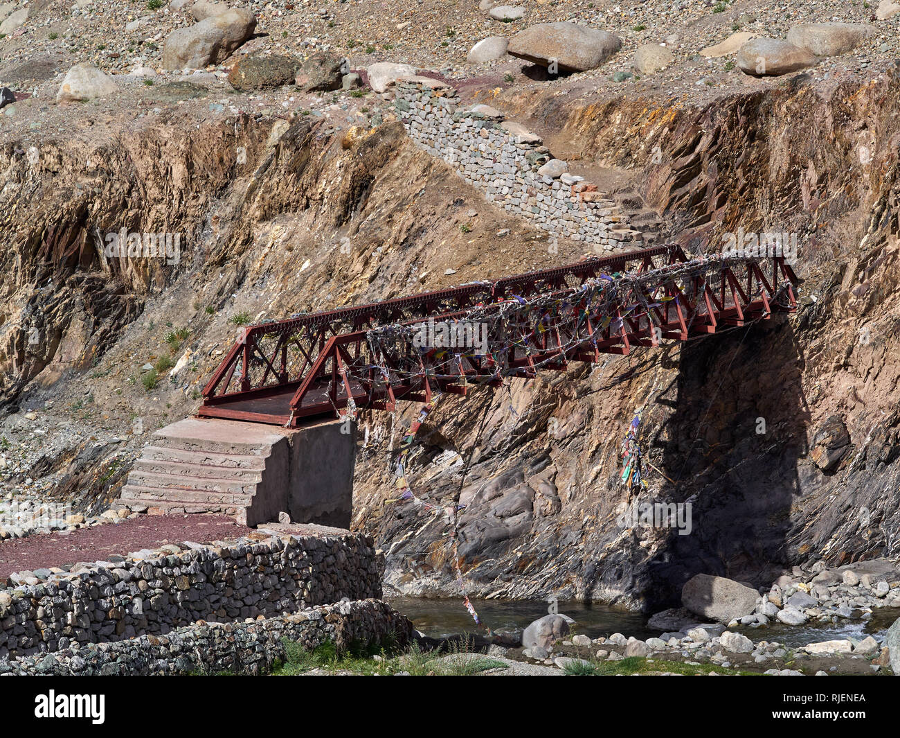 Metal powerful bridge over a mountain river. Stock Photo