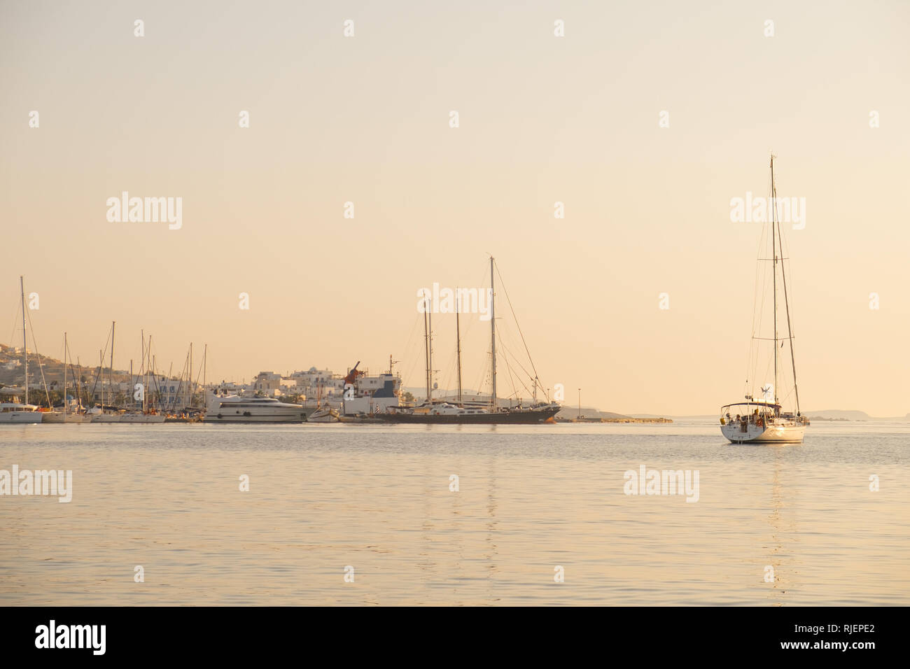 Yachts and boats in sunset near Parikia port, Paros island, Greece Stock Photo