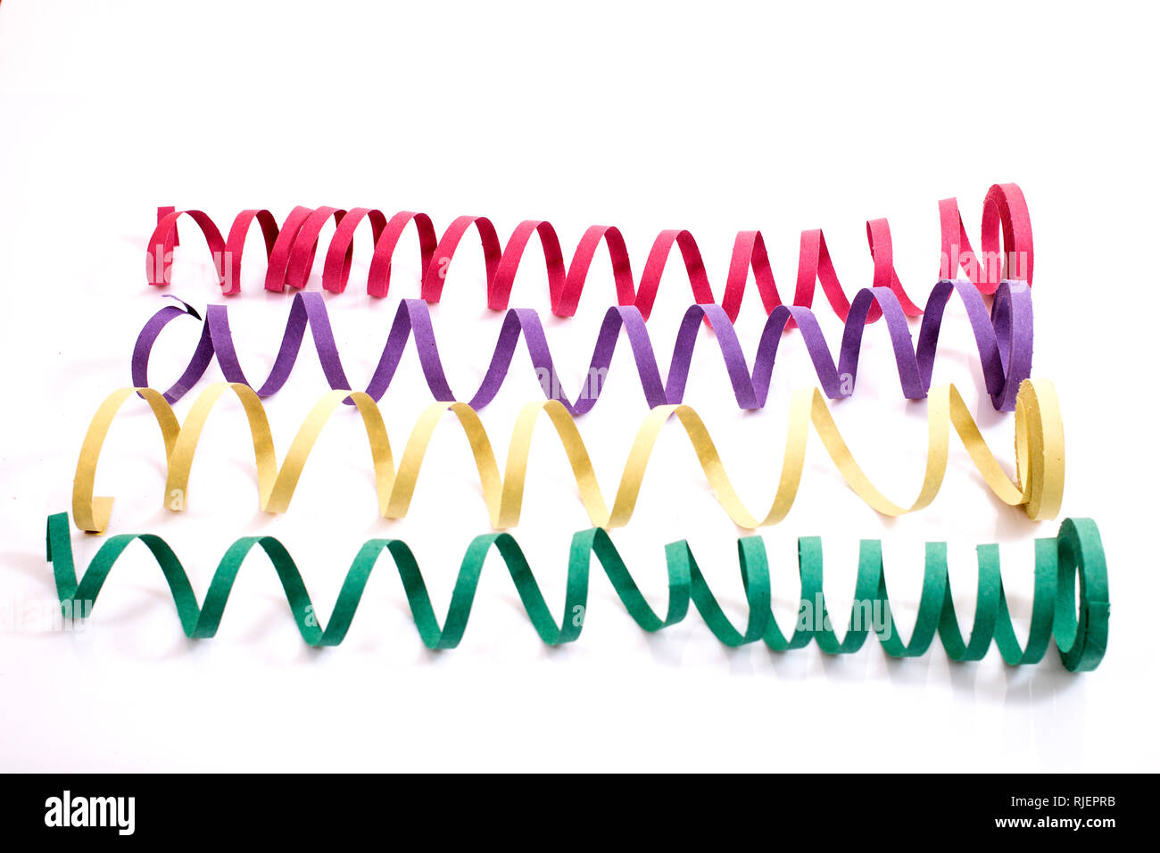 Mixed colorful streamers on a white background Stock Photo - Alamy