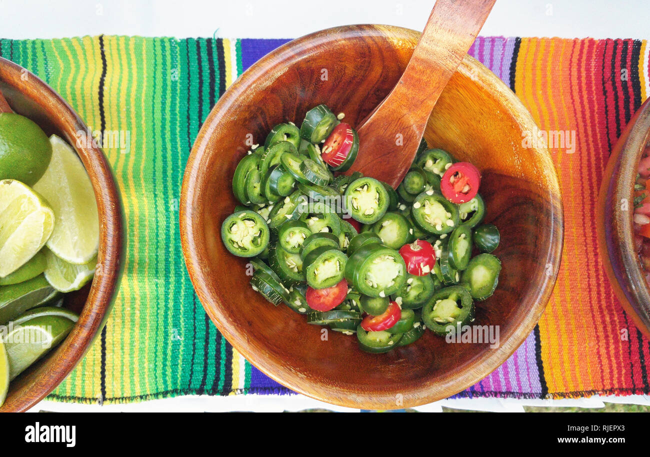 Wooden bowl with sliced jalapenos  above top view Stock Photo