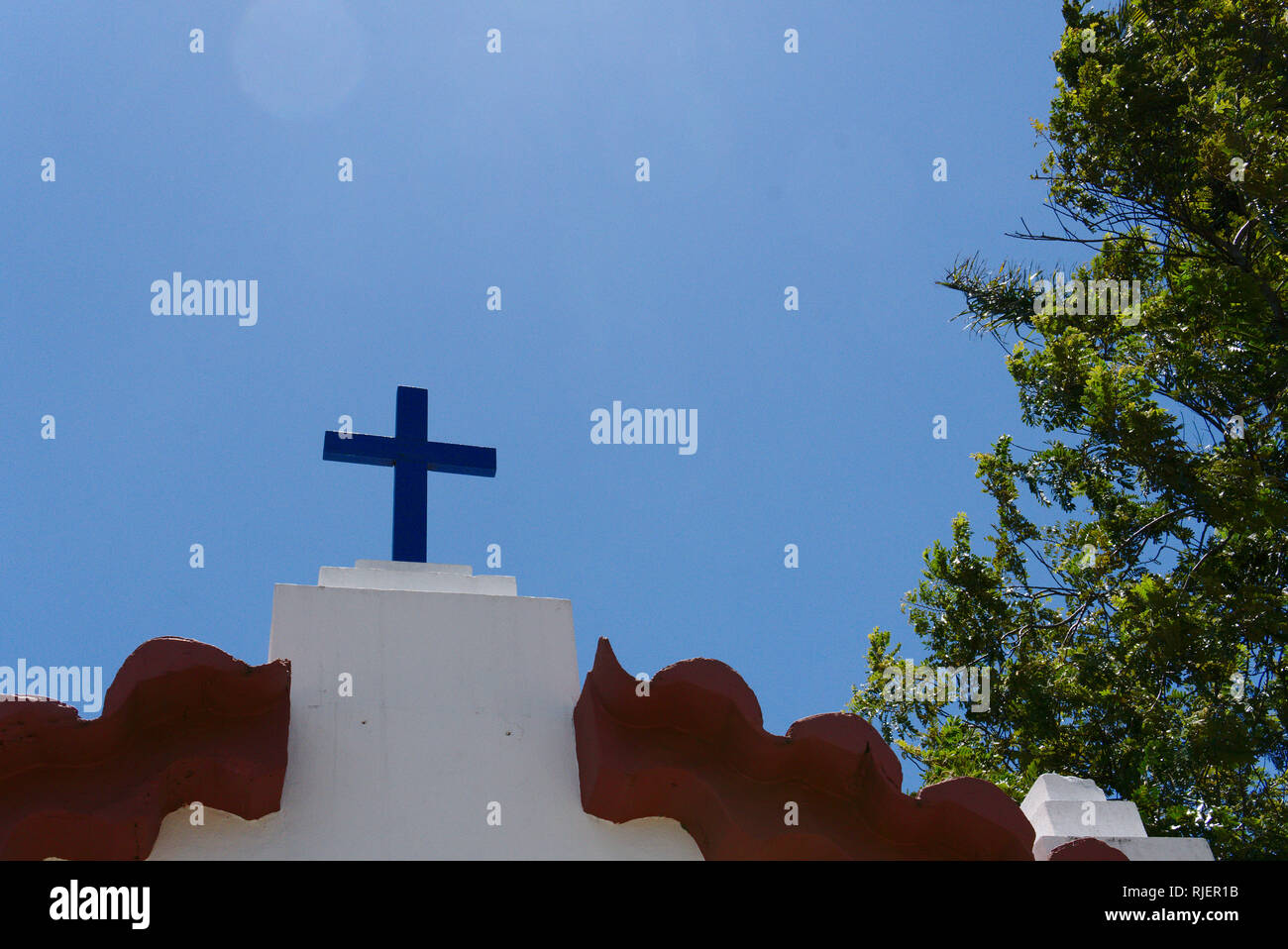 A blue catholic cross in a monastery in Latin America. Stock Photo