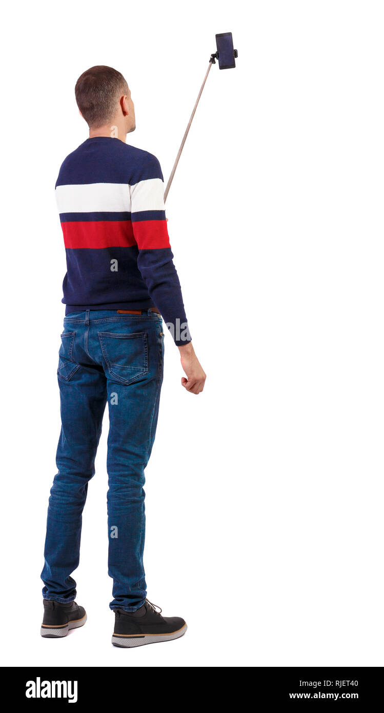 Man Using Mobile Back View back view of standing young guy with smartphone in the hands of. Rear ...