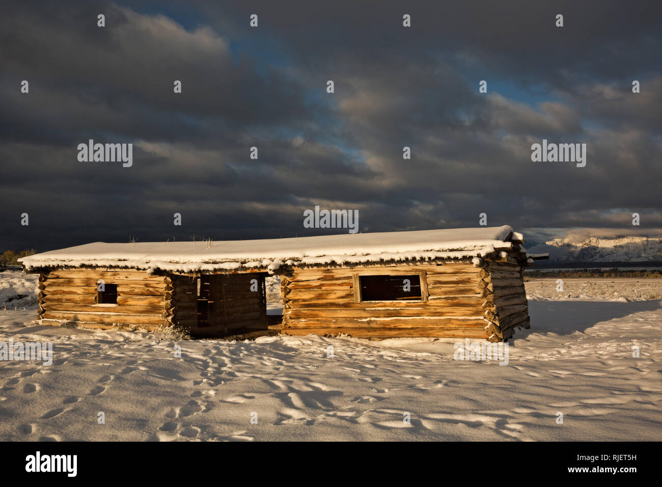 WY03211-00...WYOMING - A stormy morning sunrise at Cunningham Cabin Historic Site In Grand Teton National Park. Stock Photo