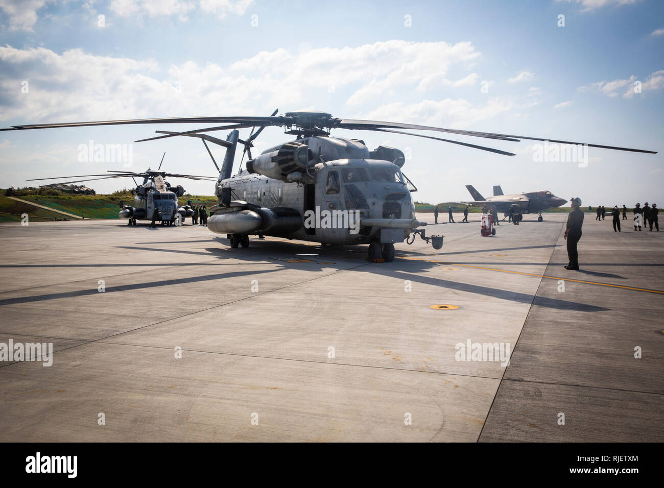 Marines perform Distributed STOVL Operations (DSO) with Marine Heavy Helicopter Squadron 465 and Marine Fighter Attack Squadron 121 on Ie Shima island, Japan, Jan. 23, 2019. The rehearsal enabled CH-53E helicopters to re-fuel and re-arm F-35B Lightning II jets from a Forward Arming and Refueling Point (FARP), significantly improving the operational flexibility, survivability, and lethality of the F-35B. The FARP provided a hot refuel and hot reload for multiple aircraft with All Up Rounds (AUR), also known as a completely assembled weapon, giving pilots the ability to stay in the fight longer, Stock Photo