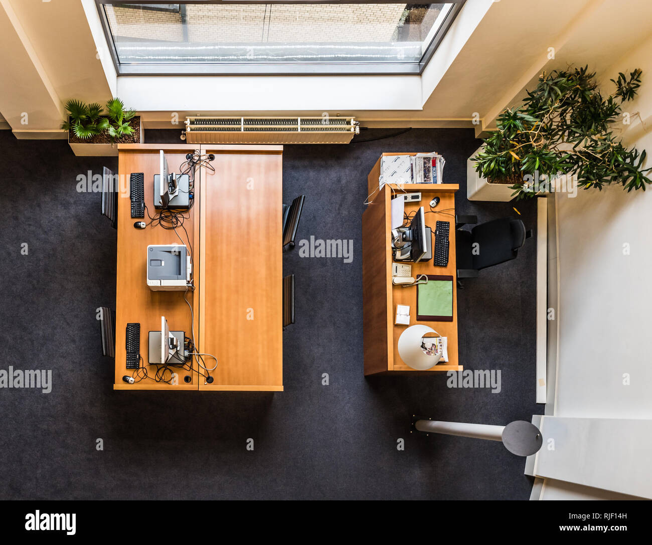 Brussels, Belgium - 02 02 2019: View from above of a wooden desk, PC, keyboard, printer and office decorations in the Brussels Parliament Stock Photo