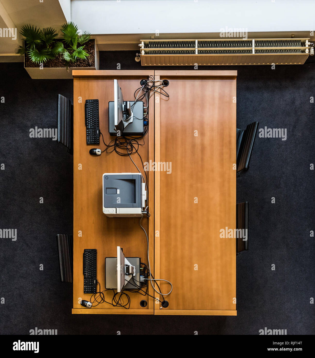 Brussels, Belgium - 02 02 2019: View from above of a wooden desk, PC, keyboard, printer and office decorations in the Brussels Parliament Stock Photo