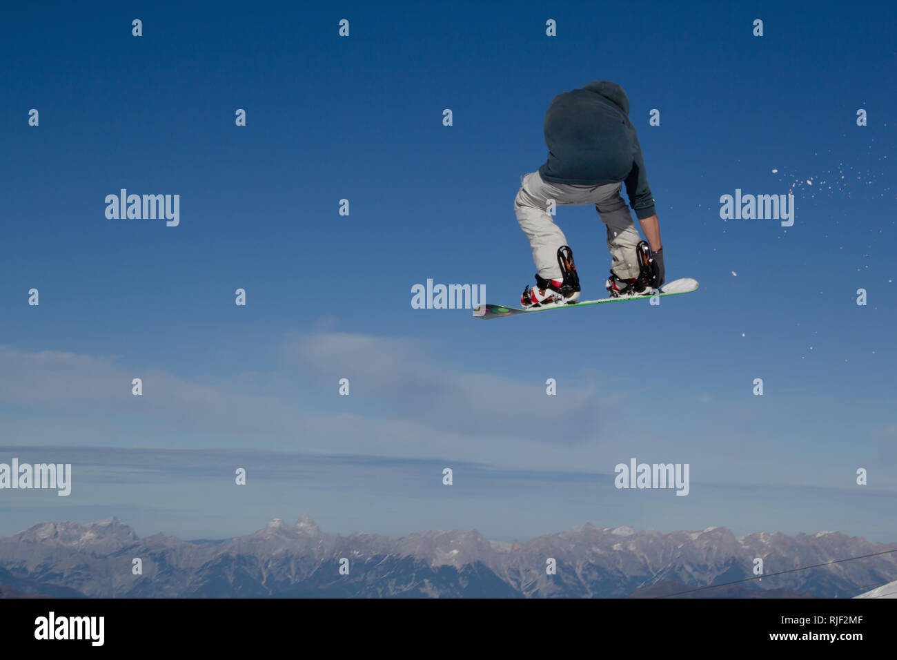 Snowboarder gets airborne after jumping over a kicker in the Kitzsteinhorn Funpark in Austria in the Alps in Europe Stock Photo