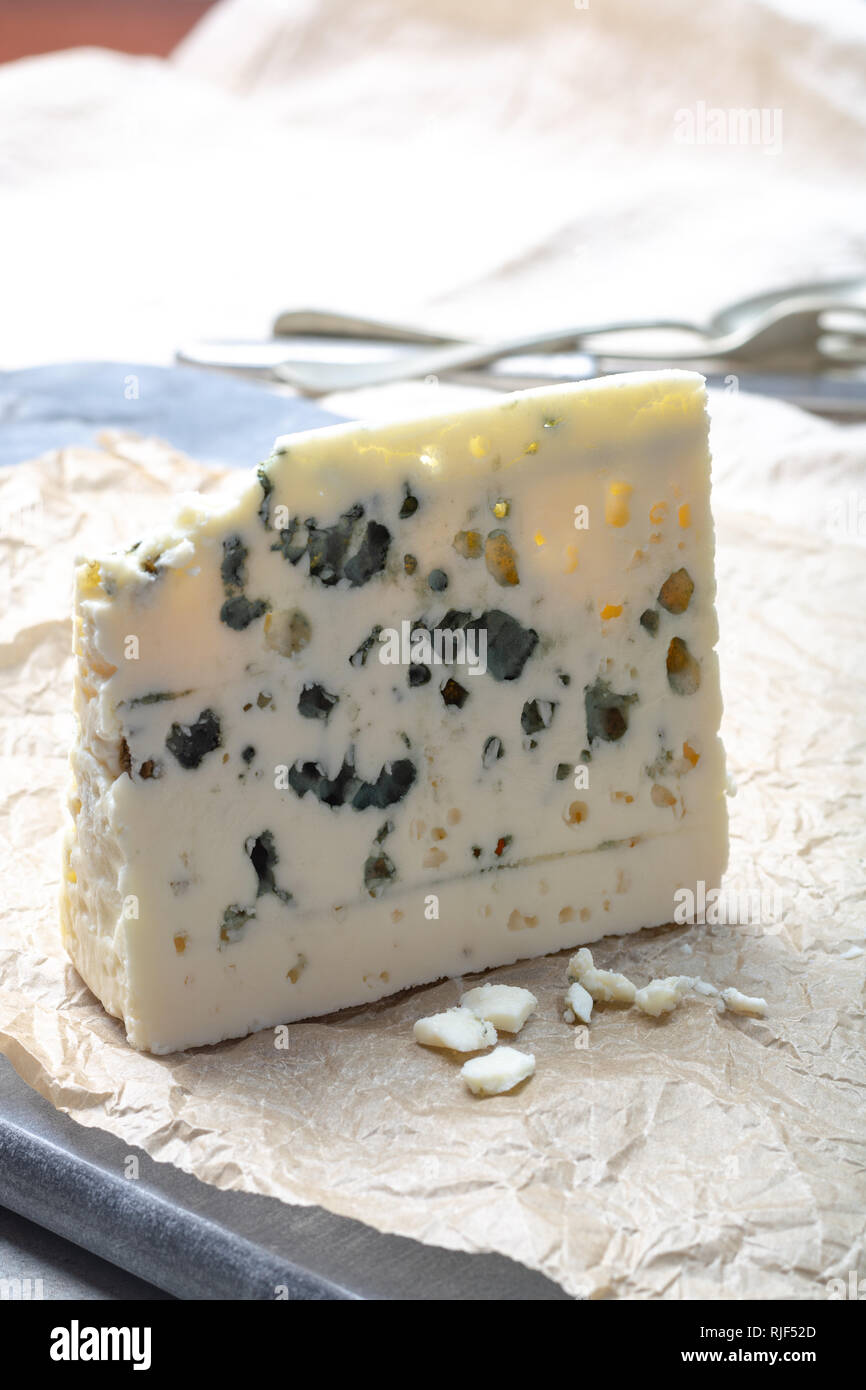 Piece of French blue cheese Roquefort, made from sheep milk in caves of RoquefortsurSoulzon