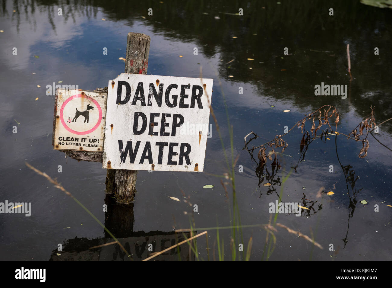 Danger Deep Water sign in a pond in a park in the UK. Stock Photo