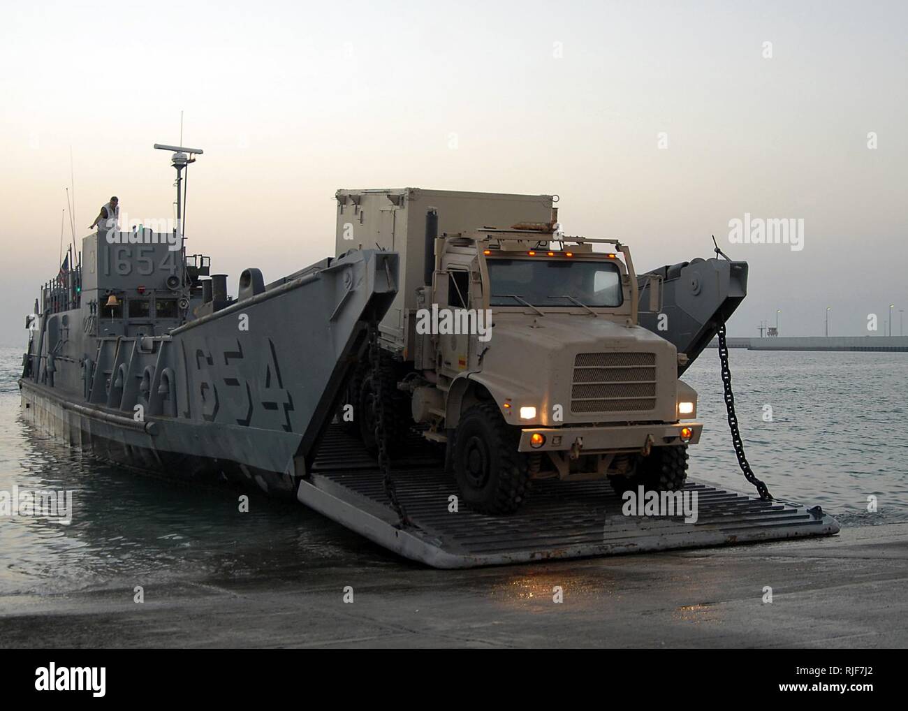 Vehicles are offloaded from a landing craft utility assigned to Assault Craft Unit 4 during amphibious operations with the amphibious dock landing ship USS Carter Hall. Carter Hall is deployed as part of the Iwo Jima Expeditionary Strike Group supporting maritime security operations in the U.S. 5th Fleet area of responsibility. Stock Photo