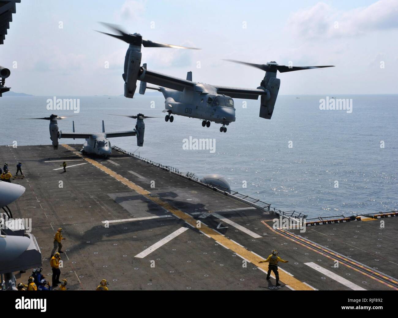 GULF OF THAILAND (Feb. 19, 2013) An MV-22 Osprey assigned to Marine Medium Tiltrotor Squadron (VMM) 265 takes off from the amphibious assault ship USS Bonhomme Richard (LHD 6) as another Osprey prepares for take-off. The Bonhomme Richard Amphibious Ready Group is deployed in the U.S. 7th Fleet area of responsibility and taking part in Cobra Gold, a Thai-U.S. co-sponsored multinational joint exercise designed to advance regional security by exercising a robust multinational force from nations sharing common goals and security commitments in the Asia-Pacific region. Stock Photo