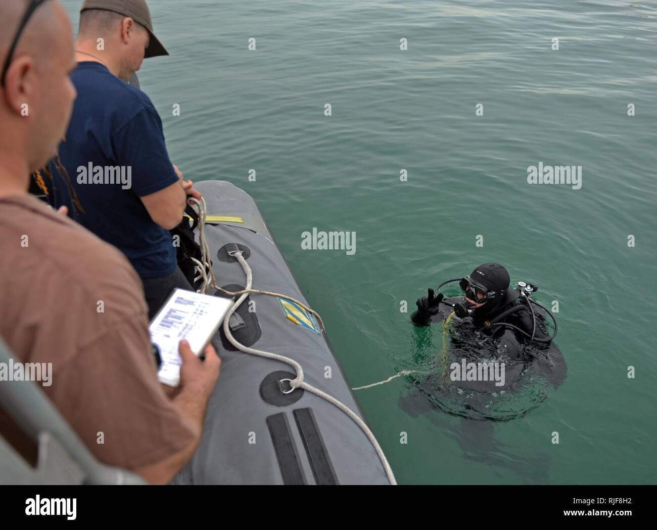 Navy diver ensures a proper seal on the Kirby Morgan 37 di…