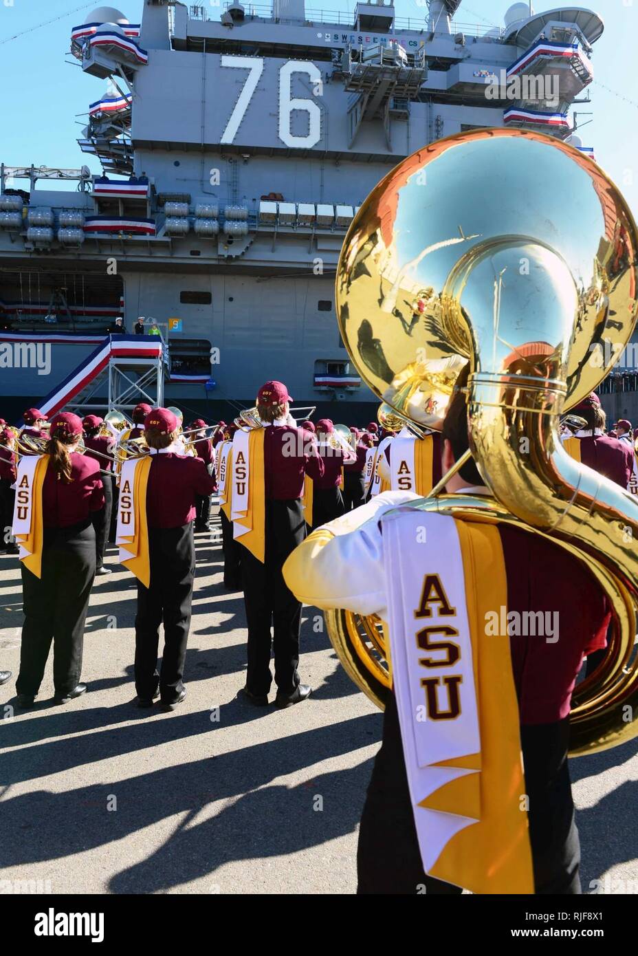 The Arizona State University marching band performs for sailors in