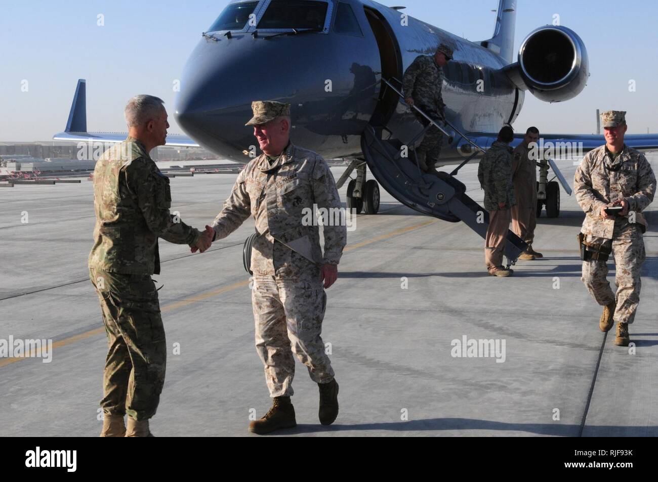 KANDAHAR, Afghanistan (December 26, 2011). Gen. James Huggin of the 82nd Airborne Division greets and shacks hands with Marine Gen James Mattis of US Central Command (USCENTCOM) right after Gen Mattis stepped of his plain on Kandahar Air Field’s. Stock Photo