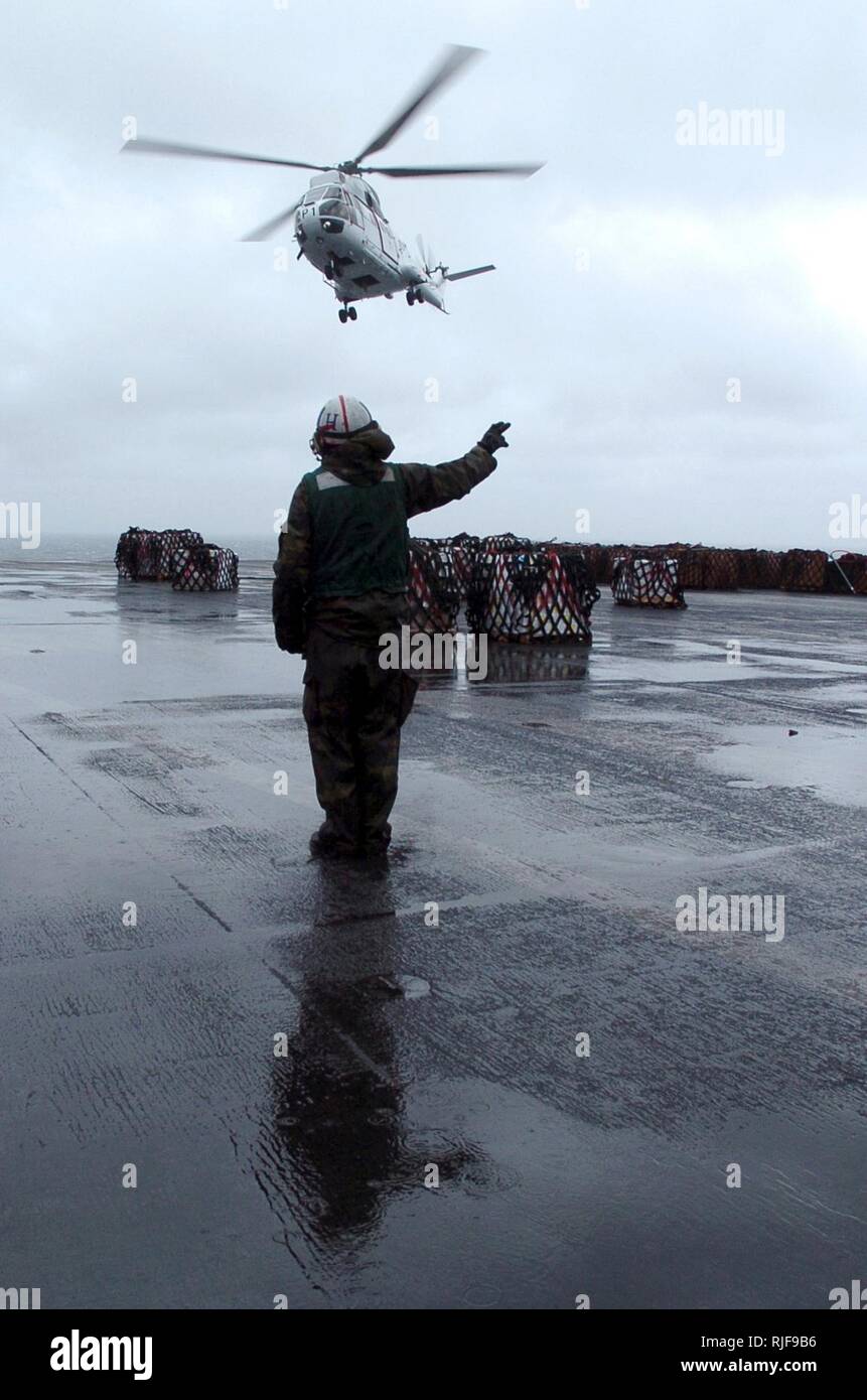 Airman Jason Simashkevich, aviation structural mechanic, assigned to the  Indians of Helicopter Anti-Submarine Squadron 6, signals an AS 332 L2 Super  Puma pilot to take off from the nuclear-powered aircraft carrier USS