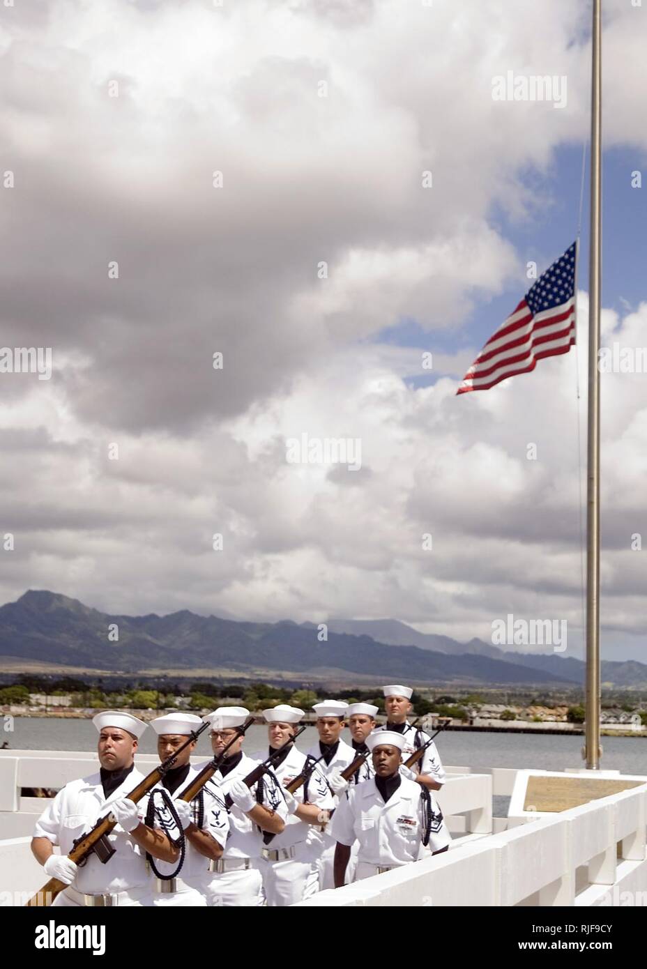 Members of the Navy ceremonial guards post after an interment ceremony at the USS Utah Memorial on Ford Island at Naval Station Pearl Harbor. The ceremony was held to honor Petty Officer First Class Jimmy Oberto, a crewmember of the Florida-class dreadnaught battleship USS Utah during the Pearl Harbor attack. Stock Photo