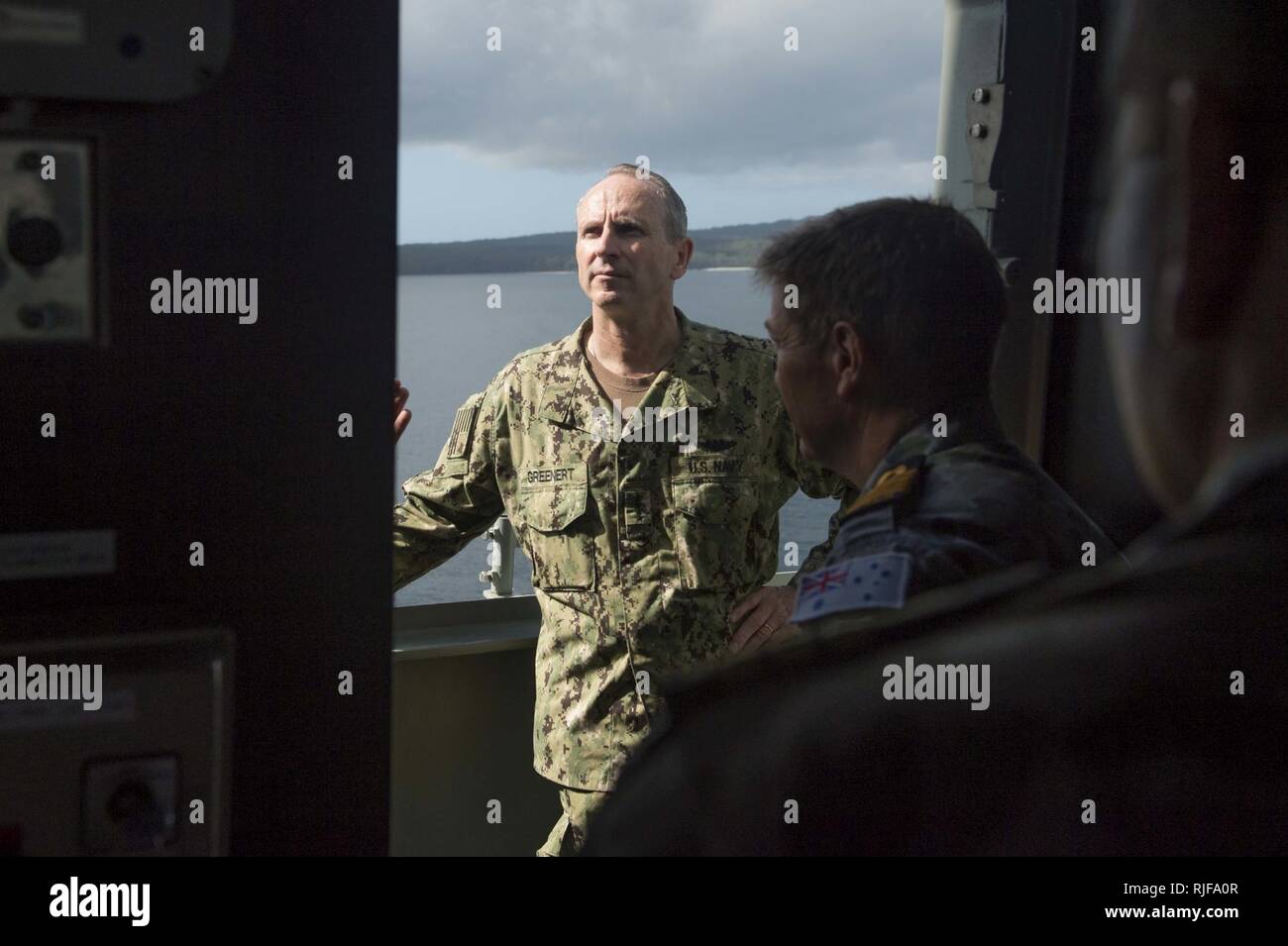 CANBERRA, Australia (Feb. 11, 2015) Chief of Naval Operations (CNO) Adm. Jonathan Greenert looks analyzes the layout and structure of the pilot house of the Canberra-class landing helicopter dock HMAS Canberra (LHD 2) during a tour of the ship. Canberra, commissioned in November 2014, will provide the Australian Defence Force (ADF) with one of the most capable and sophisticated air-land-sea amphibious deployment systems in the world once fully certified for deployment. Stock Photo