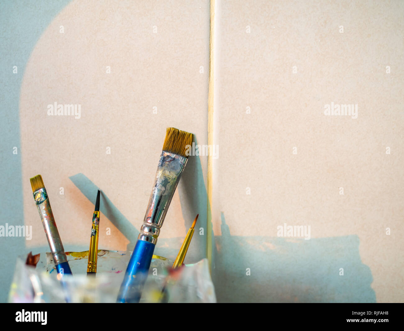 Paint brushes with gouache in cup isolated on white - Stock Photo , #spon,  #gouache, #cup, #Paint, #brushes #AD