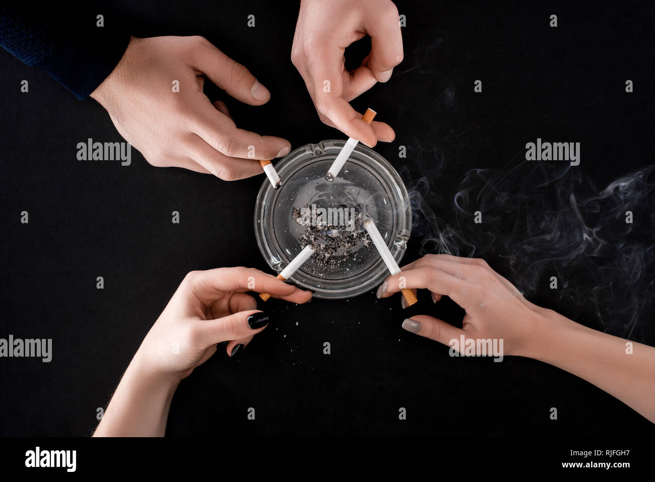 Top view of smoking people holding cigarettes Stock Photo