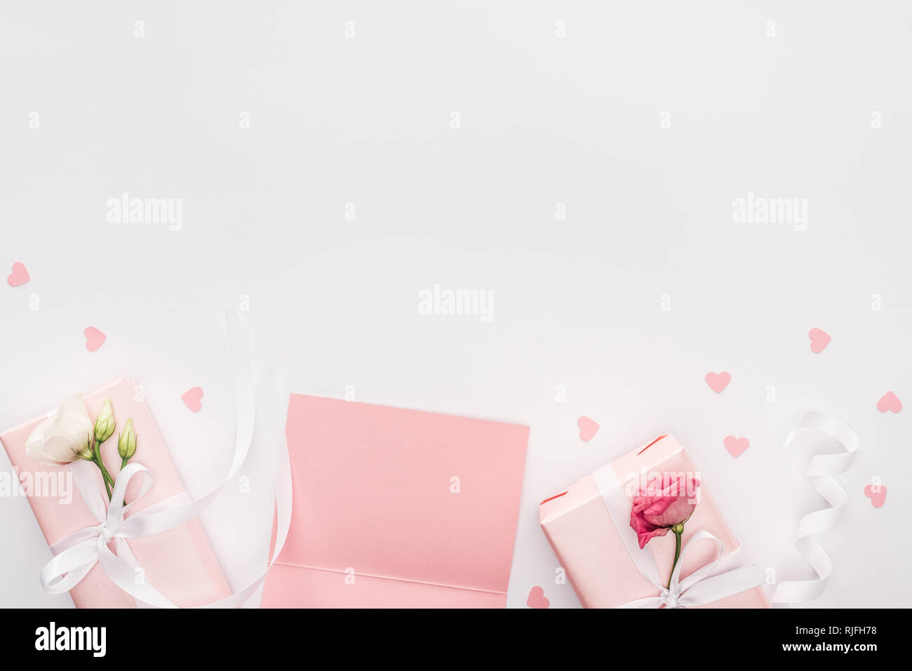 top view of gift boxes, blank card and paper hearts isolated on white ...