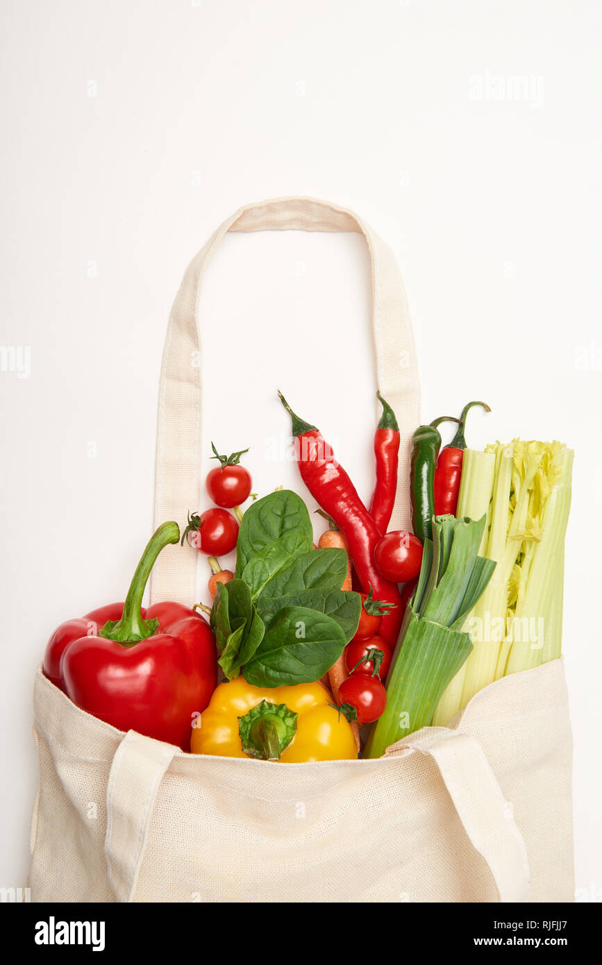 Studio shot of eco bag with natural vegetables on white background ...