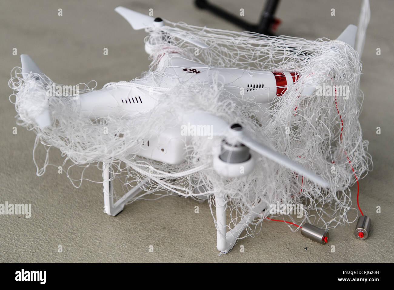 Manching, Germany. 06th Feb, 2019. A drone captured by a hunting drone with a net is shown on a presentation day of the German Armed Forces to track down and fend off the drone. During a presentation day at the Manching airfield near Ingolstadt, it will be demonstrated how the flying objects can be detected, forced to an emergency landing with interference radiation or taken down from the sky with an interceptor drone. Credit: Matthias Balk/dpa/Alamy Live News Stock Photo
