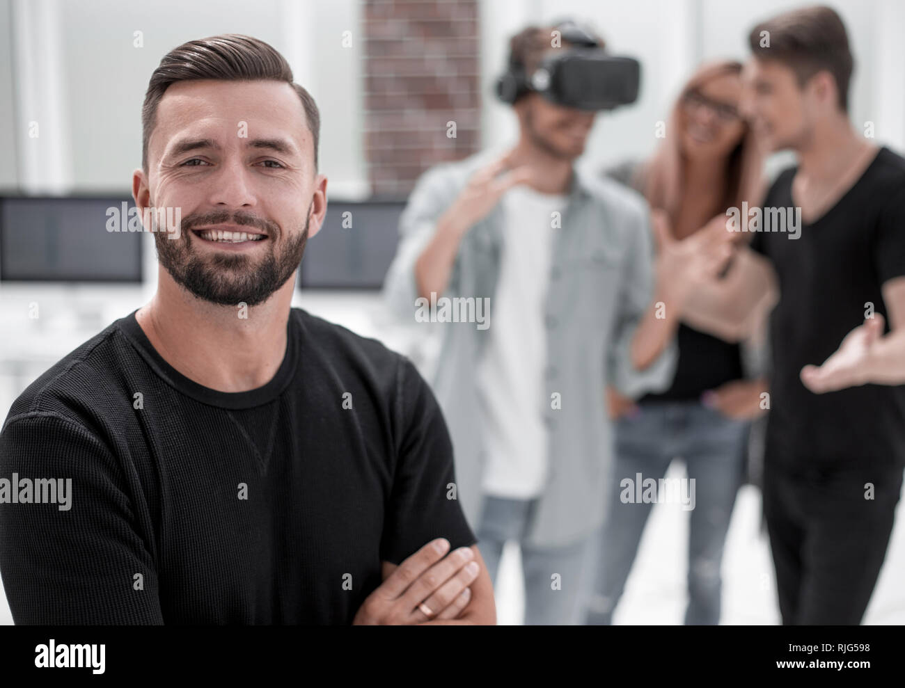 Cheerful colleagues testing virtual reality glasses Stock Photo