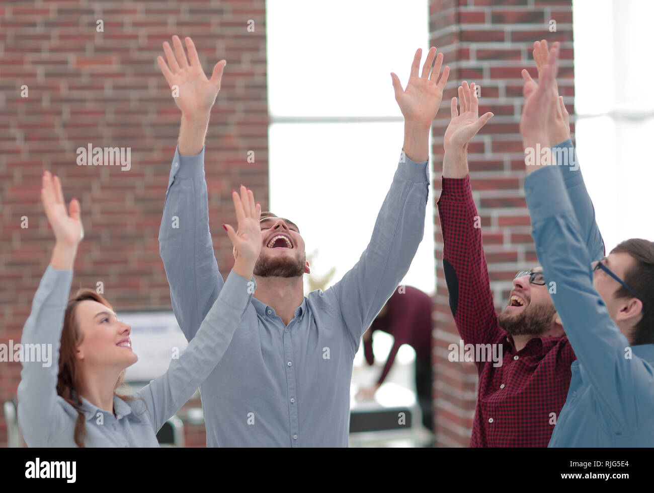 Happy smiling business team in office Stock Photo - Alamy