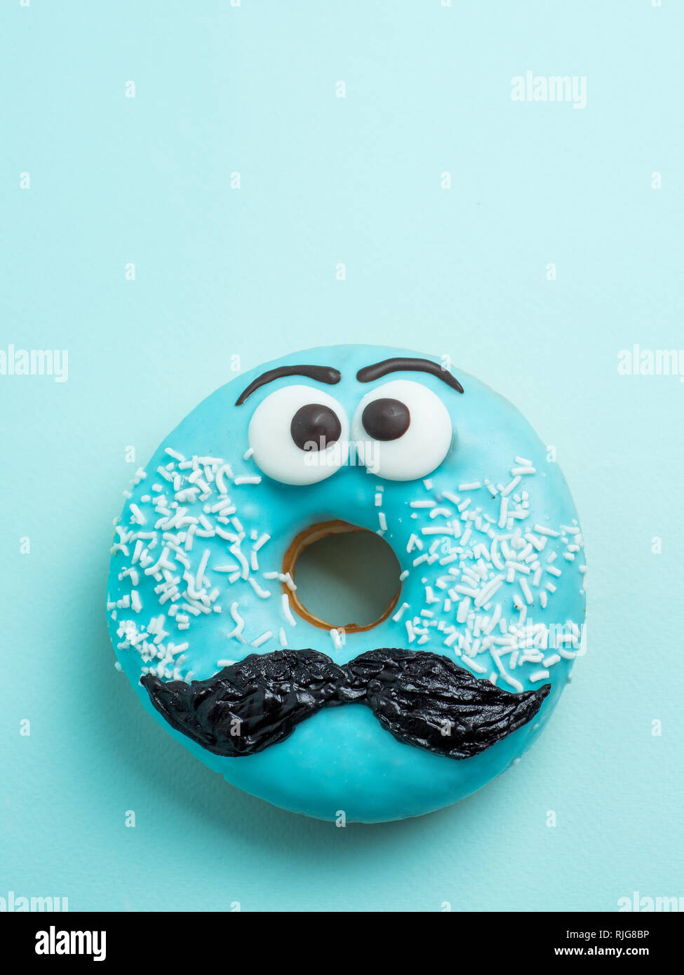 Funny blue glazed donut on pink background. Pastel Stock Photo - Alamy, image size:975x1390