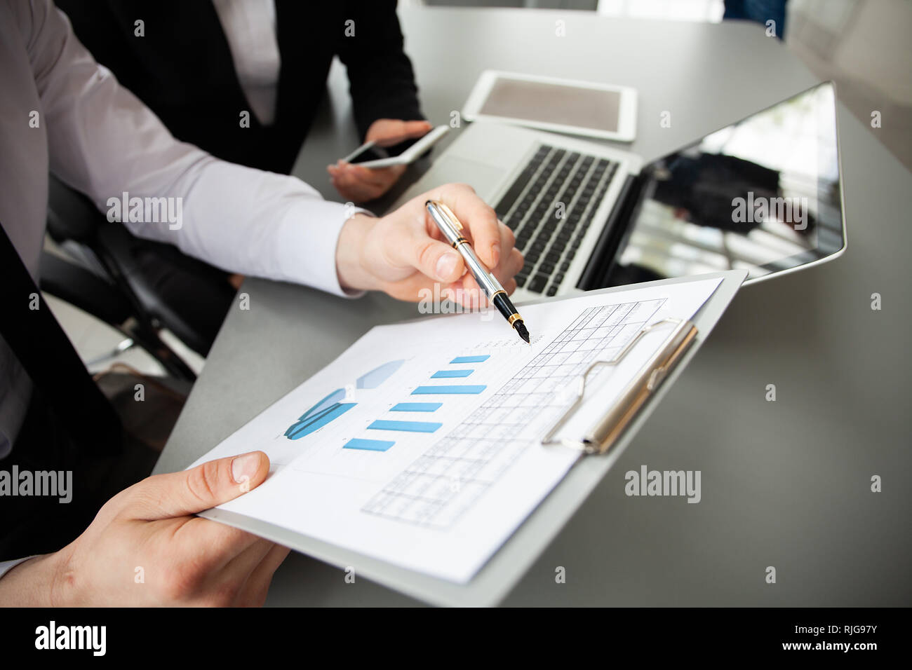 co-working team meeting concept, businessteam using smartphone and digital tablet and laptop computer in modern office. Stock Photo