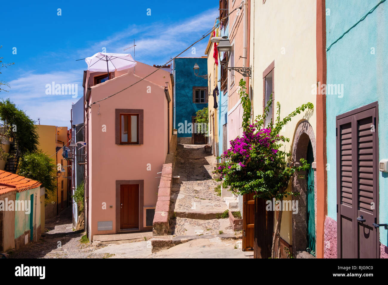 Bosa, Sardinia / Italy - 2018/08/13: Bosa historic old town quarter with colorful tenements and narrow street of Via Muruidda Stock Photo