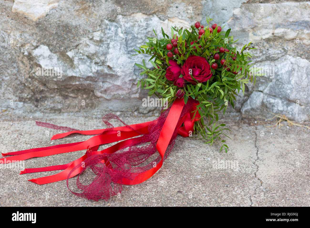 wedding bouquet of red roses, hypericum and pistache Stock Photo