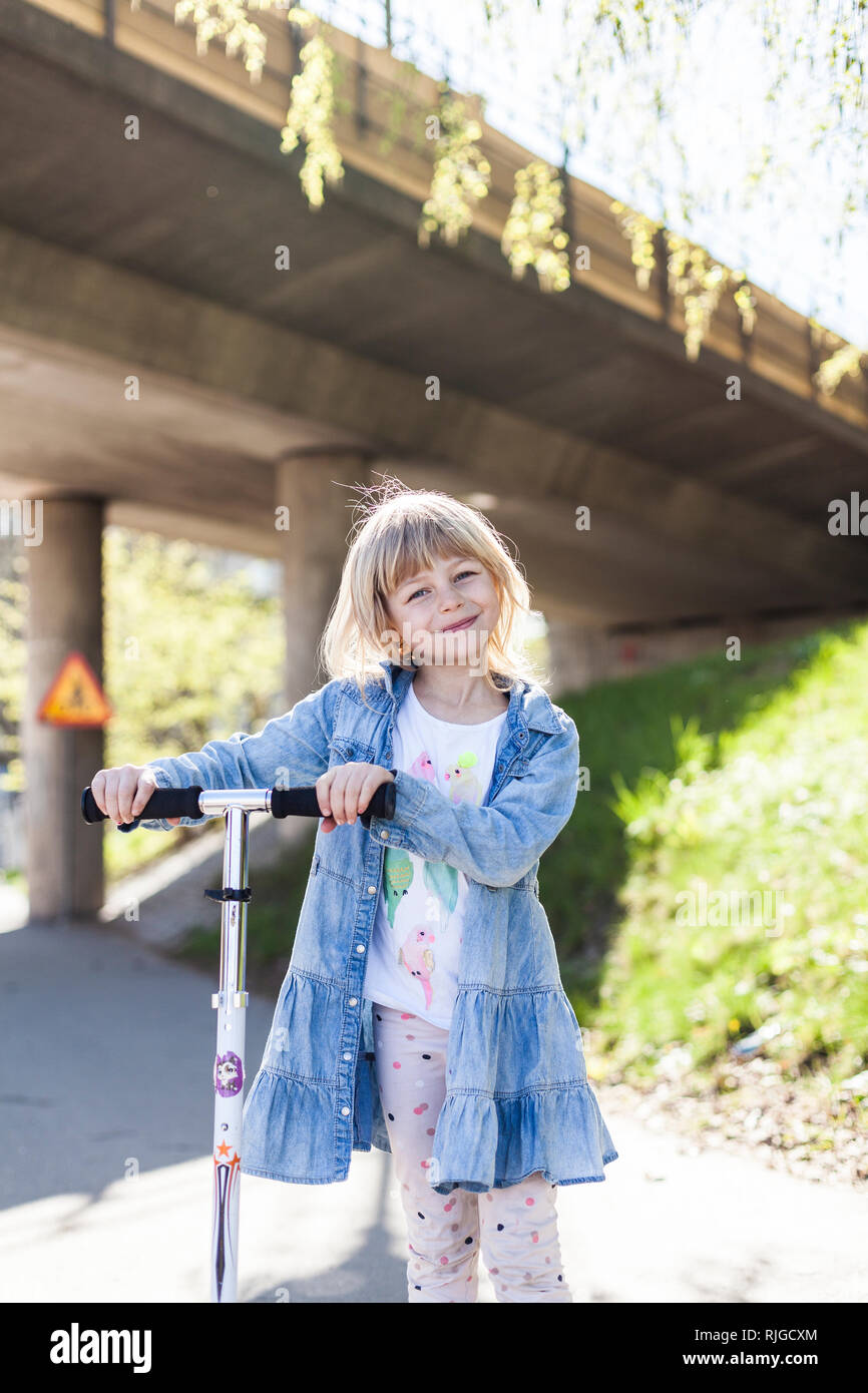 Girl on a scooter Stock Photo Alamy
