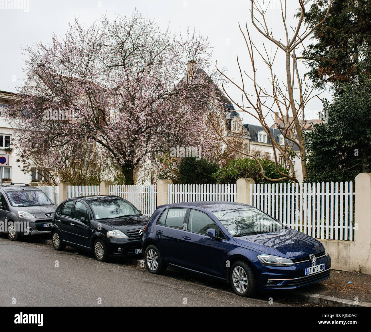 PARIS, FRANCE - SEP 22, 2017: New German Volkswagen Golf small car car parked on the street next to Citroen and Peugeot car covered with rain drops Stock Photo
