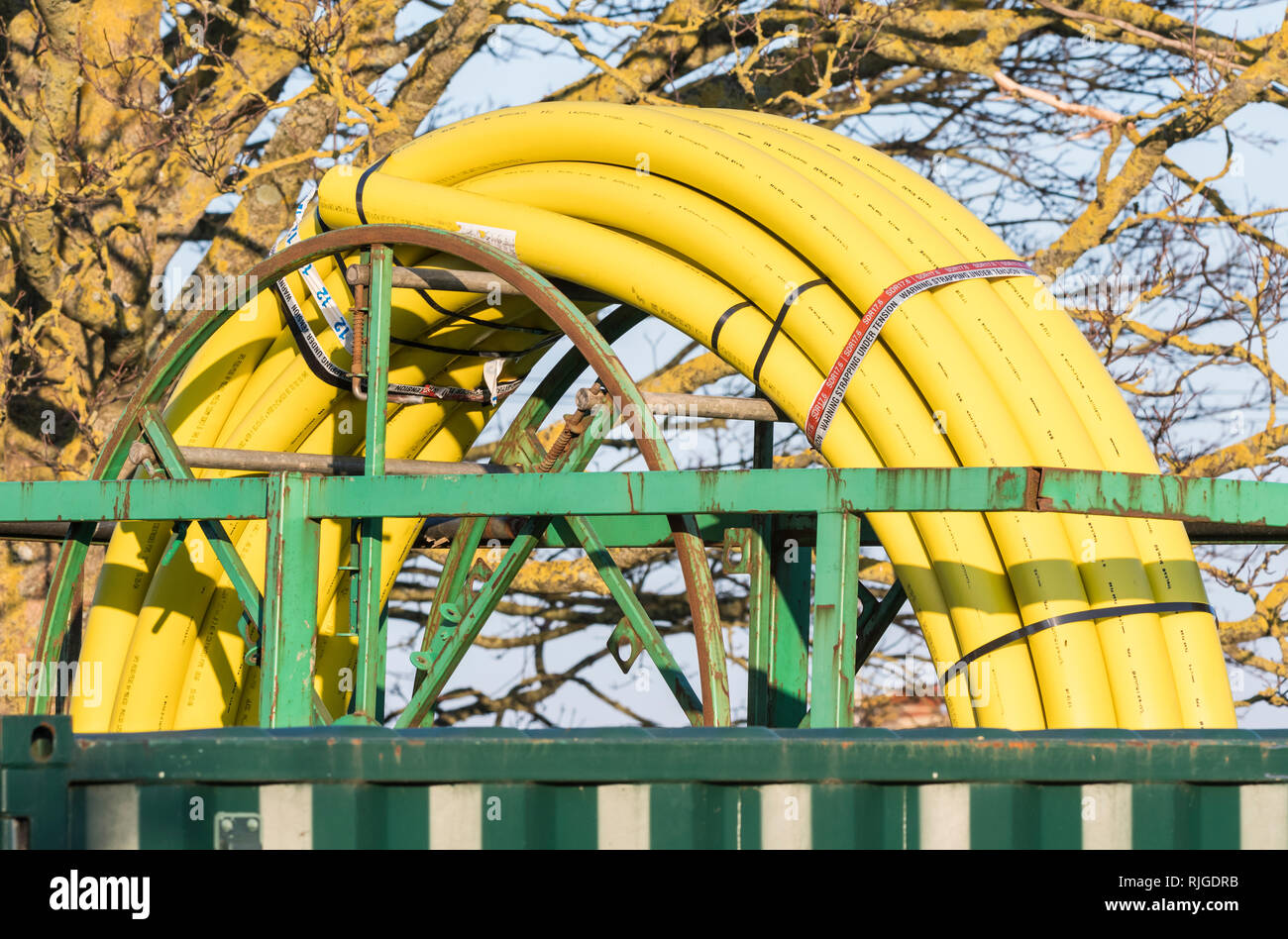 SDR17.6 PE80 Polyethylene yellow coiled gas pipe, ready for use underground as part of renewing gas supplies in the UK. Stock Photo