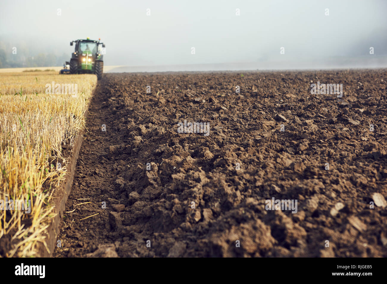 Tractor on field Stock Photo - Alamy