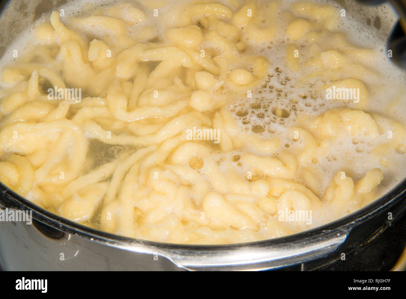 German noodles called Spaetzle cooking in a pot Stock Photo