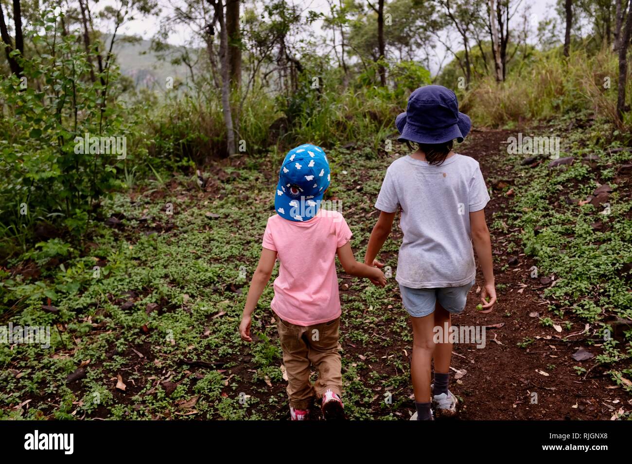 Young school age children walking along a dirt track, Moongun walking