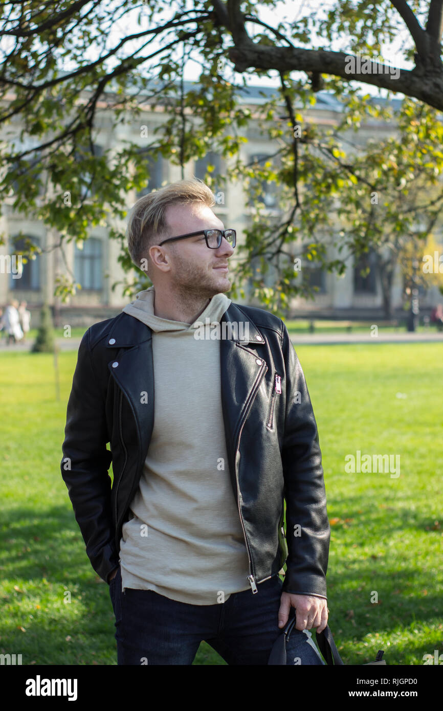 Smart smiling guy in casual clothes, looking left Stock Photo