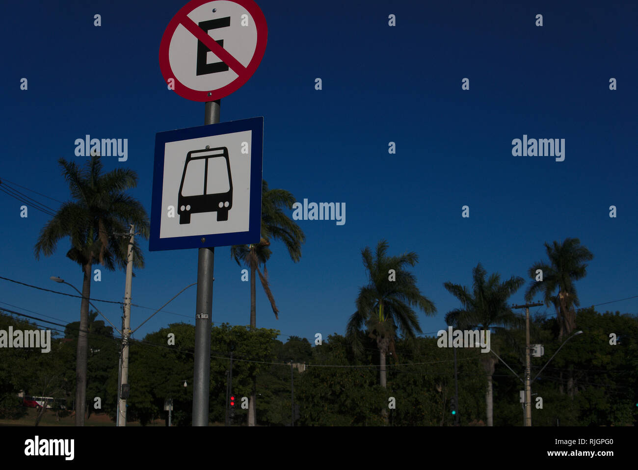 Bus stop and parking sing (in Portuguese) in a street near to the beach. Stock Photo