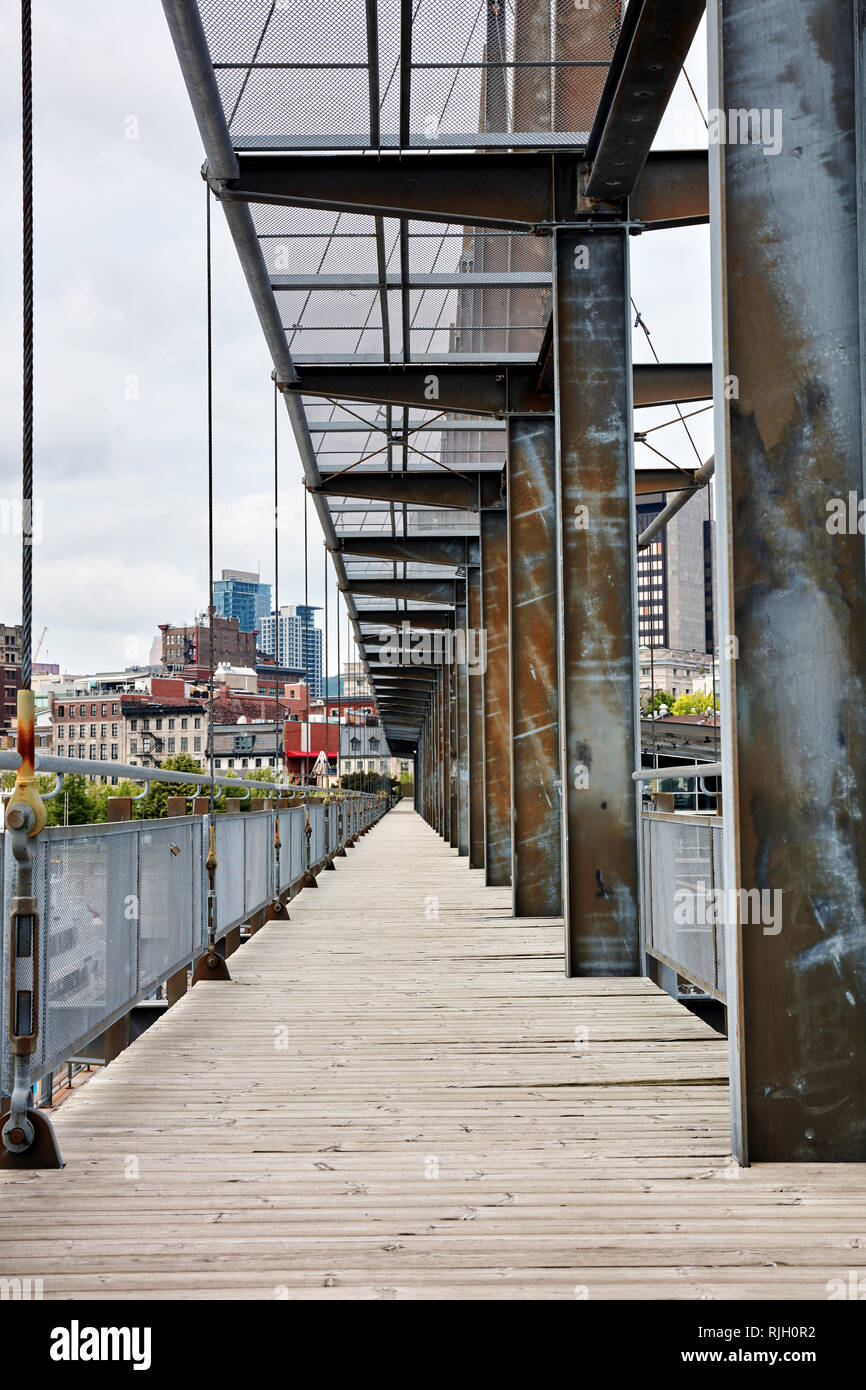 Old bridge made of wooden plank floorboard and metal steel girder in the city Stock Photo