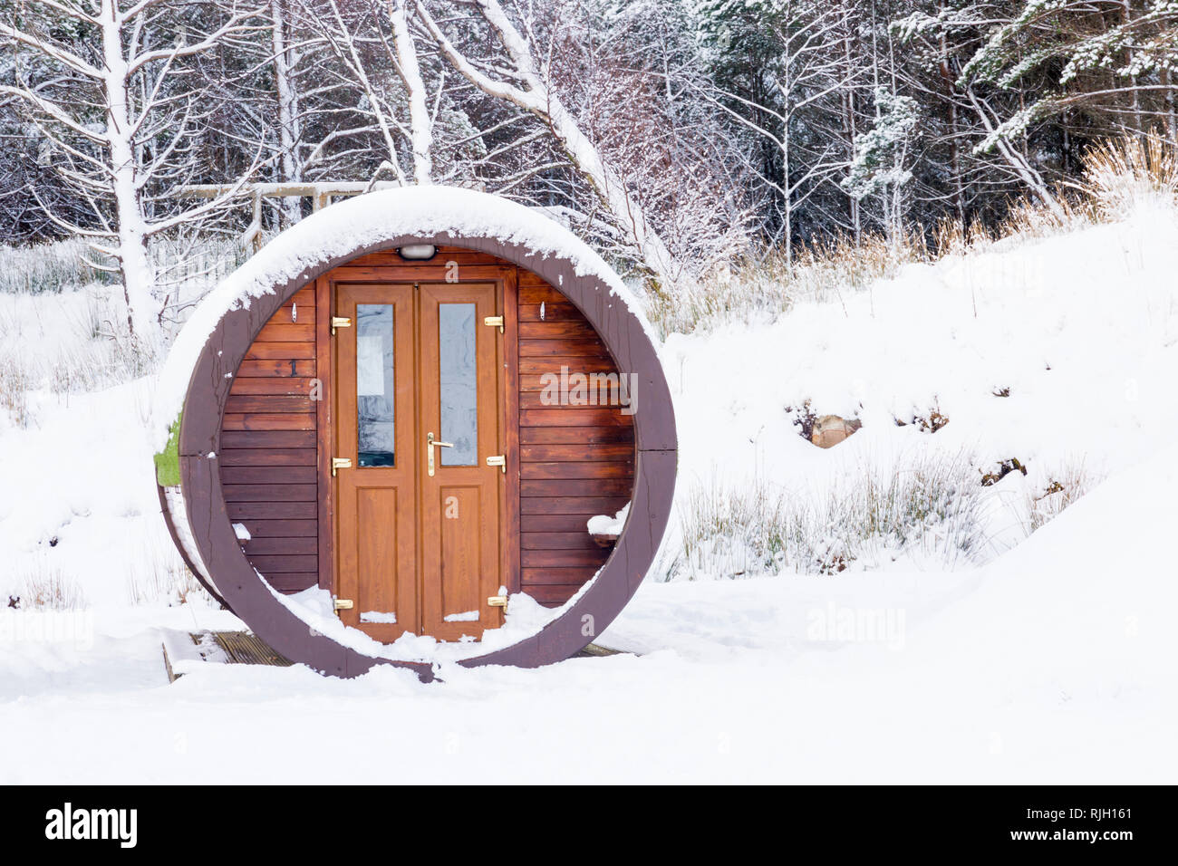 Microlodges accommodation at Glencoe mountain resort at Glencoe, Highlands, Scotland in Winter covered in snow Stock Photo